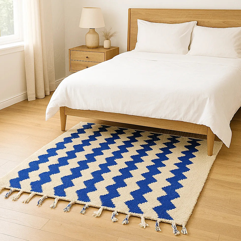 A Moroccan area rug in pure wool, showcasing geometric blue lines on a beige background, handmade in Beni Mellal for a refined interior style.