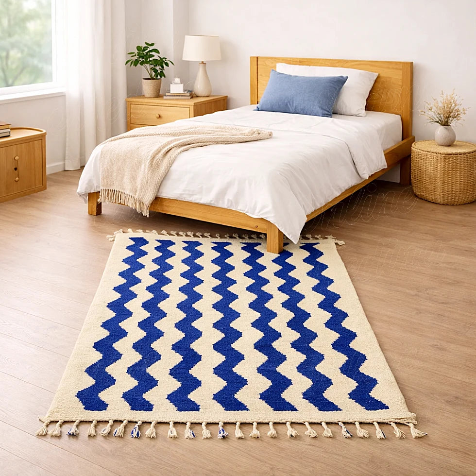 A Moroccan area rug in pure wool, showcasing geometric blue lines on a beige background, handmade in Beni Mellal for a refined interior style.