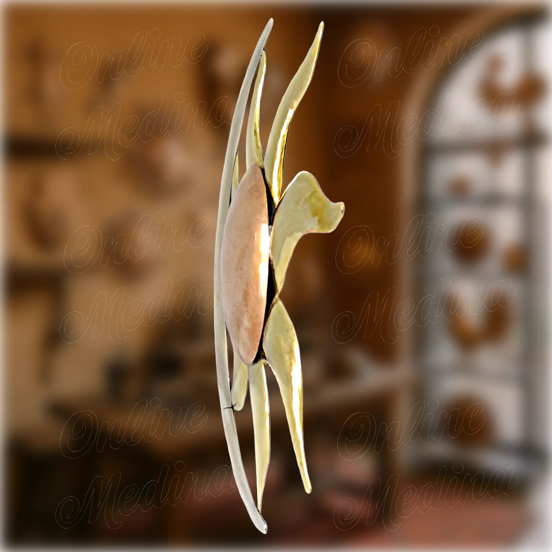 Side view of Moroccan handcrafted sun and moon metal wall decor in copper and brass.