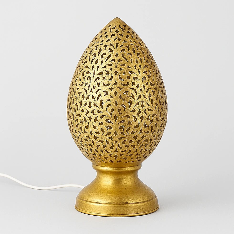 Moroccan egg-shaped perforated table lamp in brass with floral cutout design on plain background – Online Medina handmade lighting