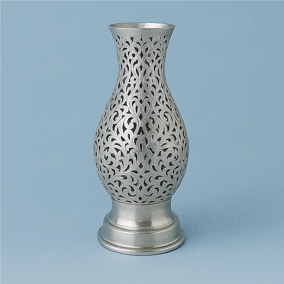 Openwork amphora candleholder, silver-colored finish, on a blue background.