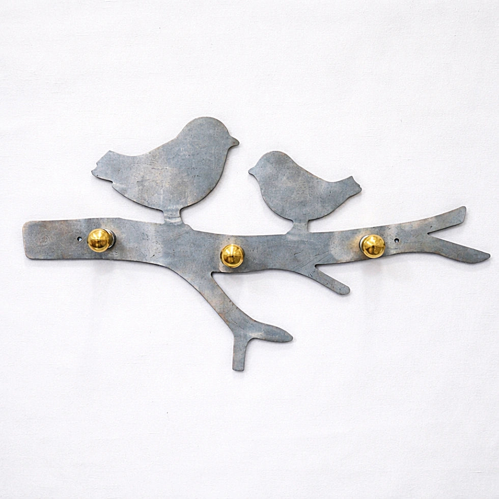 Heated galvanized metal bird wall key holder with natural patina and brass hooks, handcrafted artisan wall decor