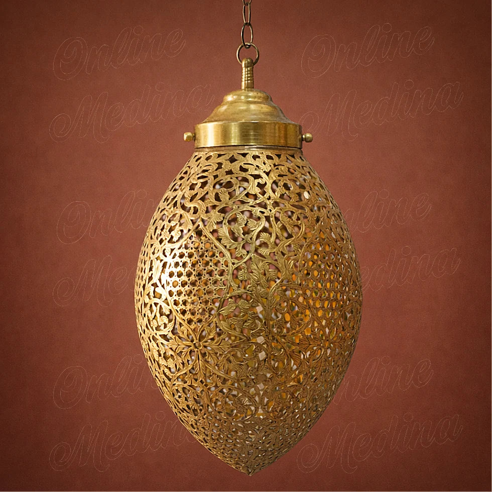 Large handmade Moroccan brass pendant light with detailed openwork design displayed on a warm terracotta background