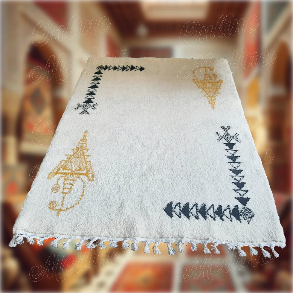 White Moroccan Khelala rug with handwoven black and gold Berber motifs — a perfect mix of warmth, elegance, and tradition.