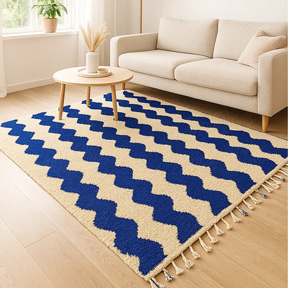A Moroccan handmade wool rug with striking blue and cream wavy lines, woven in the Beni Mellal region and ideal for contemporary living spaces.