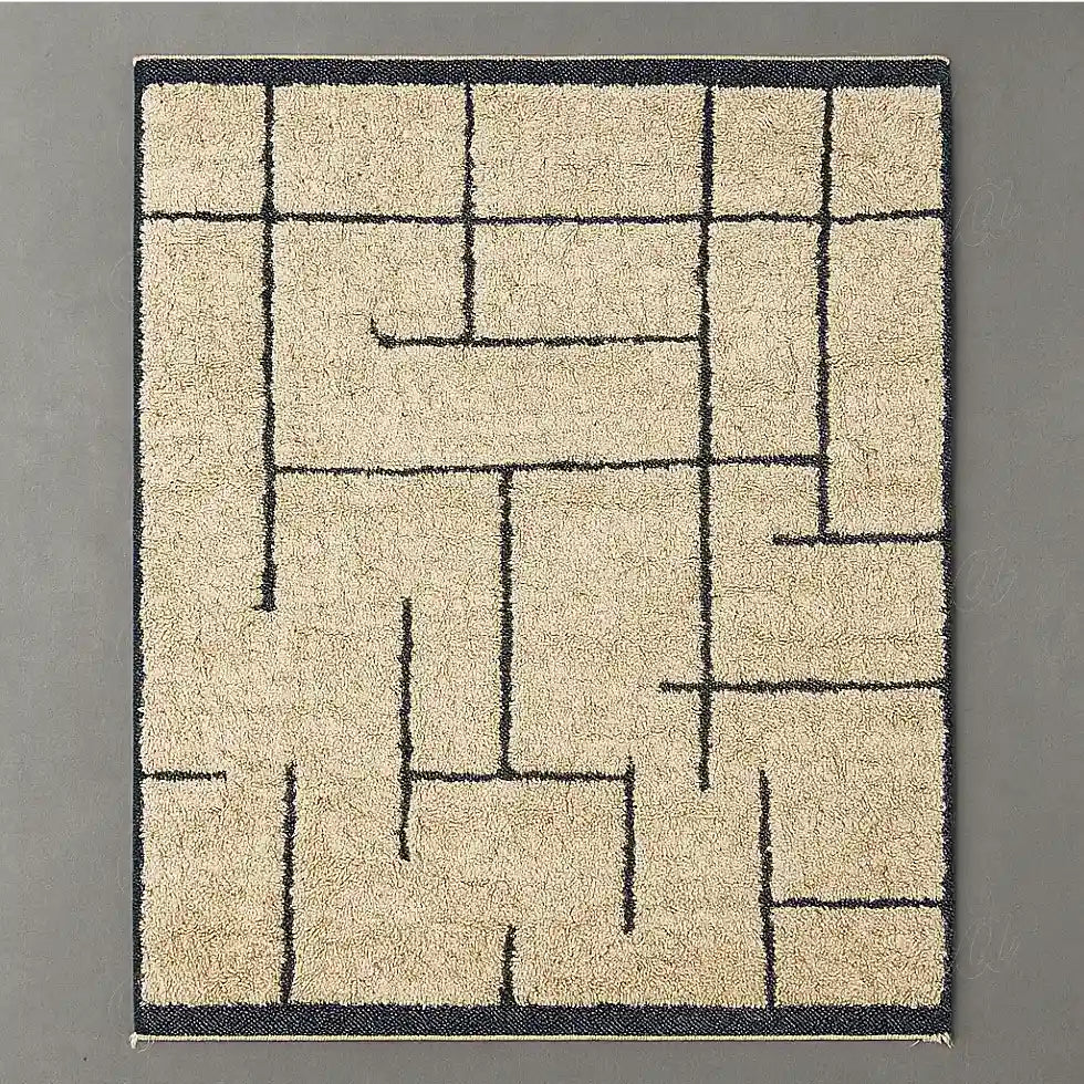 Modern Berber rug in natural wool with black geometric lines on a light beige background.