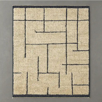 Modern Berber rug in natural wool with black geometric lines on a light beige background.