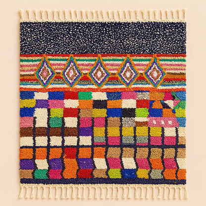 Studio shot of a Boujaad rug with Sahara-inspired geometric patterns and fringes displayed on a clean neutral background