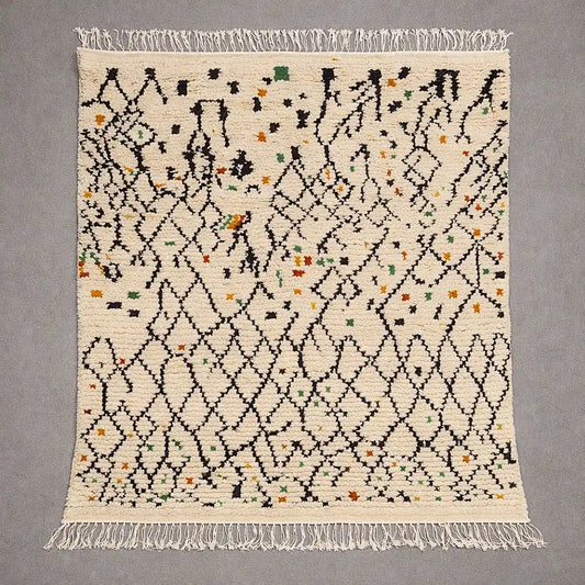 Flat view of a Boujaad Azilal Berber rug handwoven in natural wool, cream base with black geometric lines and colorful accents