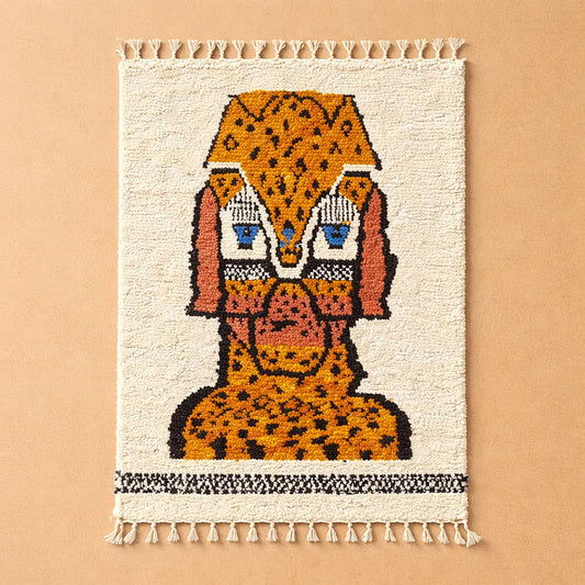 Handmade Moroccan rug with animal motif photographed on a plain background