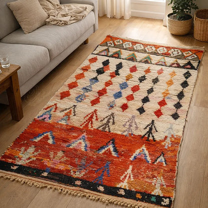 Handmade Moroccan Azilal rug with red and tribal motifs displayed in a European living room