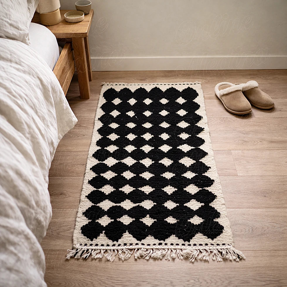 Berber runner rug with black geometric pattern in a bedroom, soft ivory background and textured wool finish