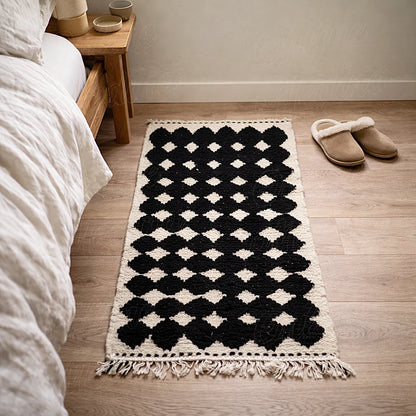 Berber runner rug with black geometric pattern in a bedroom, soft ivory background and textured wool finish