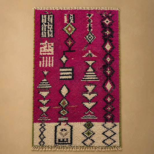 Magenta Boujad rug with symbolic tribal pattern on wool, shown in a clear flat lay studio view