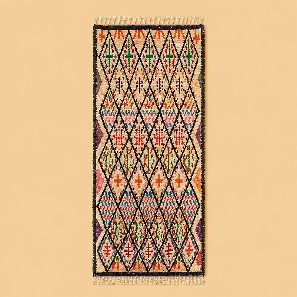 Colorful Moroccan Berber runner rug with diamond motifs on plain background