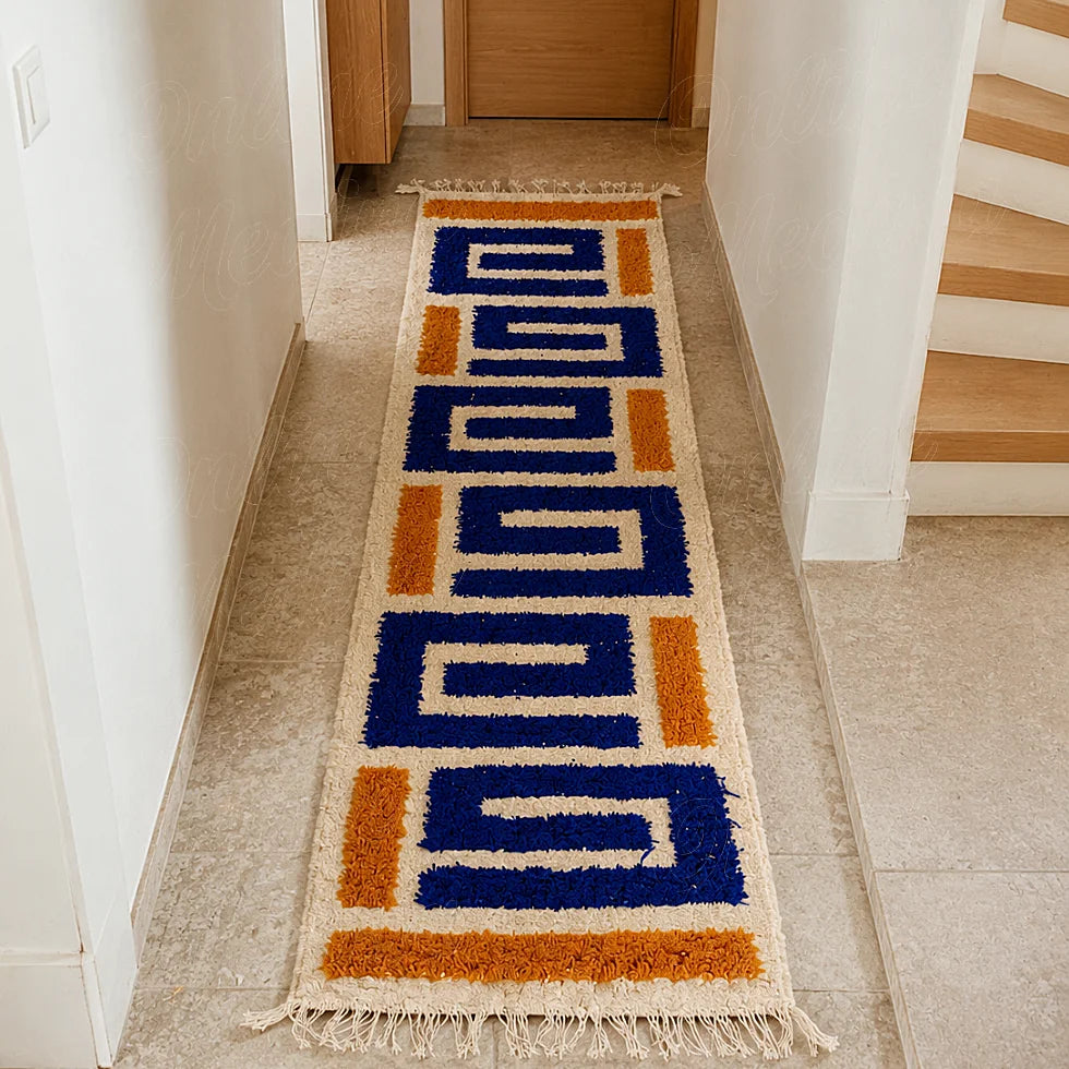 Modern Moroccan Berber runner rug with blue geometric motifs in a bright hallway