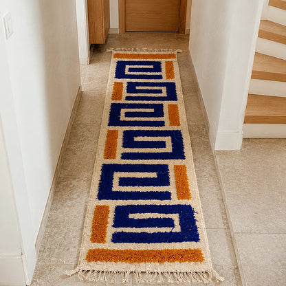 Modern Moroccan Berber runner rug with blue geometric motifs in a bright hallway
