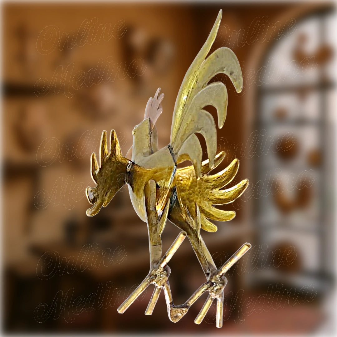 Close-up view of a handcrafted Moroccan rooster made of golden brass with a red copper crest – traditional hammered metal sculpture from Marrakech