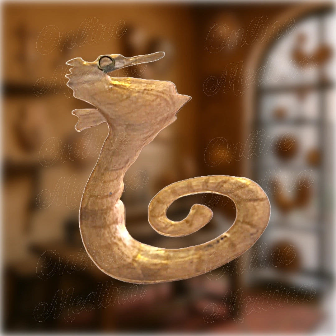 Close-up of handcrafted copper seahorse sculpture with spiral tail, artisanal wall decoration made by a master craftsman in Marrakech.