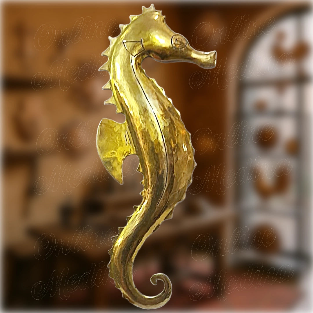 Decorative seahorse sculpture in polished brass, handcrafted in Marrakech by a master craftsman, with detailed ridged contour.