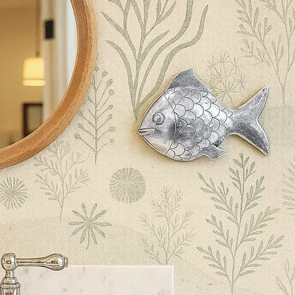 silver tin alloy fish wall decoration in bathroom with sea plant wallpaper and mirror