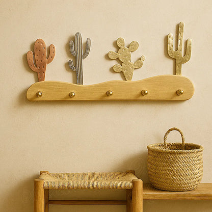 Handmade Moroccan cactus coat rack with mixed metal cacti and brass hooks, displayed above a woven bench and basket in a warm interior