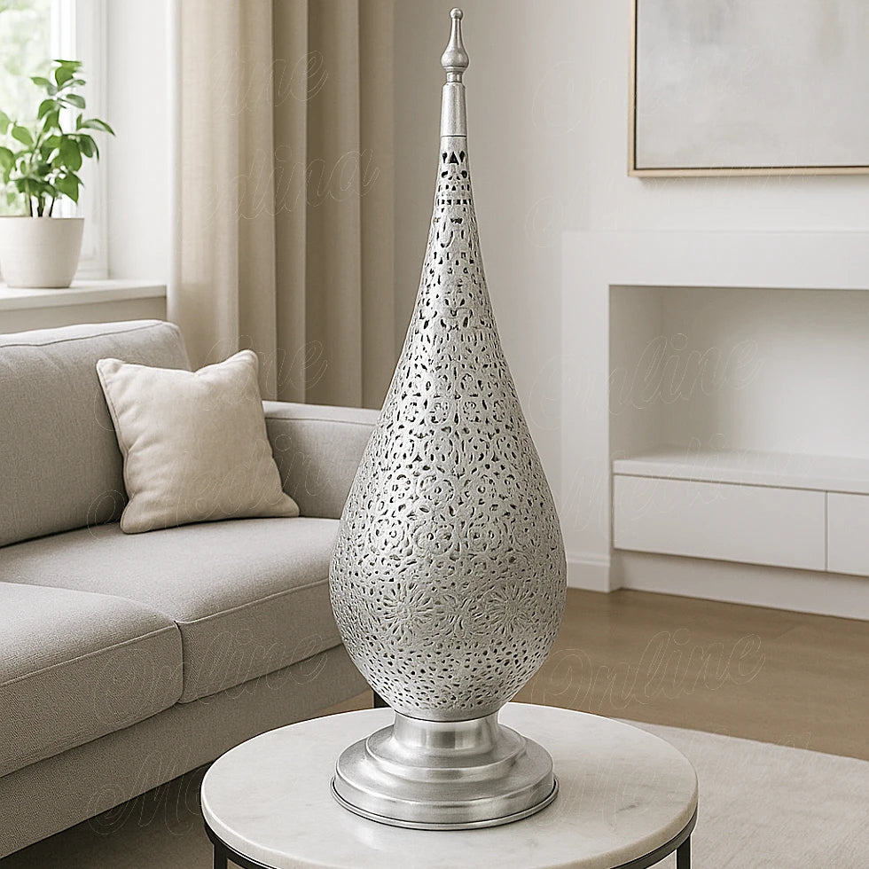 Oriental silver-tin alloy lamp with floral openwork design, softly illuminating a beige European-style living room.