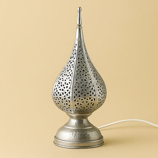 Silver tear-drop Moroccan lamp with hammered geometric pattern, handcrafted metalwork on neutral beige background
