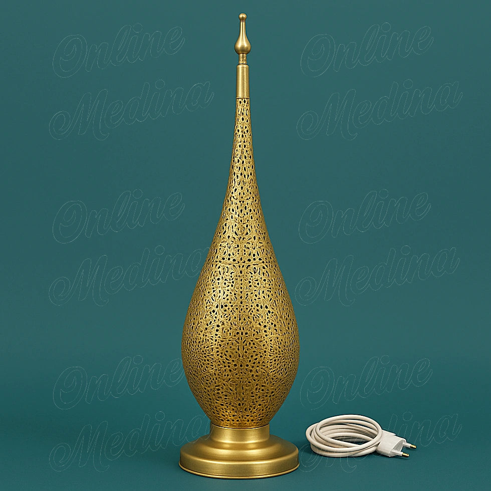 Moroccan brass lamp with hand-carved patterns, shown on a plain green background with visible cable and switch for a clean e-commerce look.