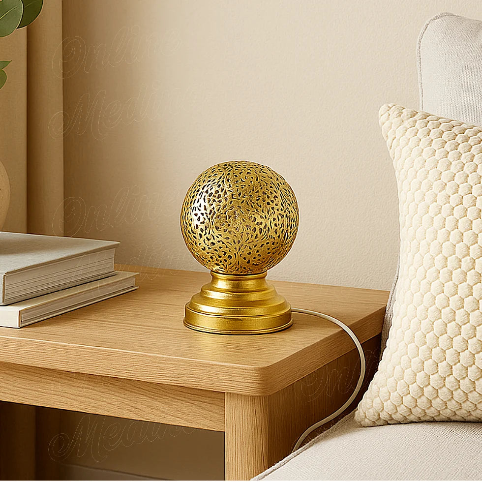 Moroccan brass table lamp with floral openwork pattern on a bedside table