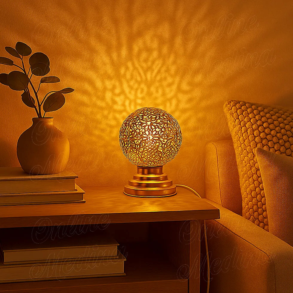 Lit Moroccan brass globe lamp casting warm floral shadows on the wall