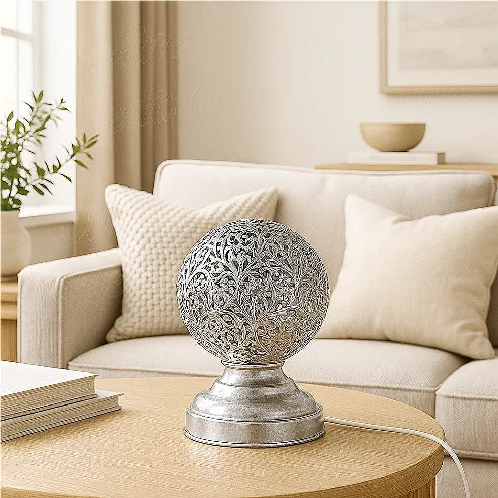Silver Moroccan table lamp with handmade pierced floral design in a bright living room