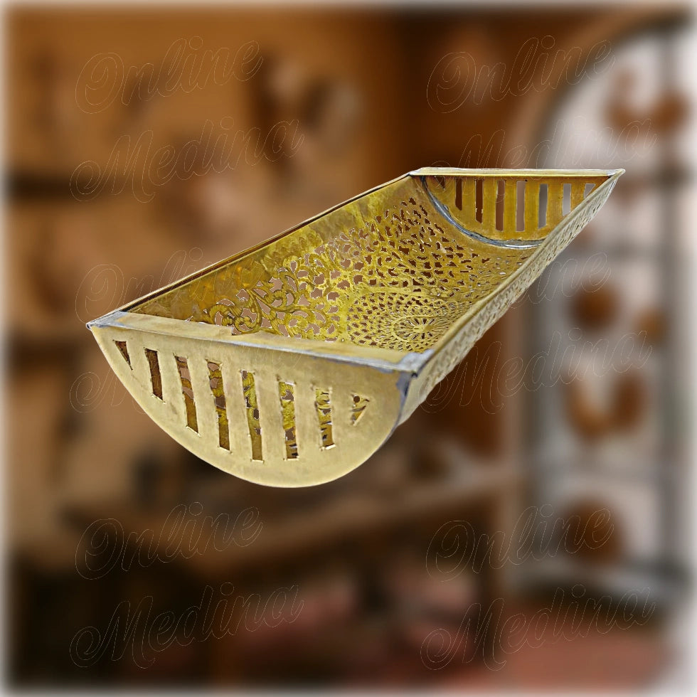 Moroccan artisan wall sconce in silver-colored metal alloy, with finely chiseled arabesque motifs and rounded front design – decorative lighting for hallways or living spaces.