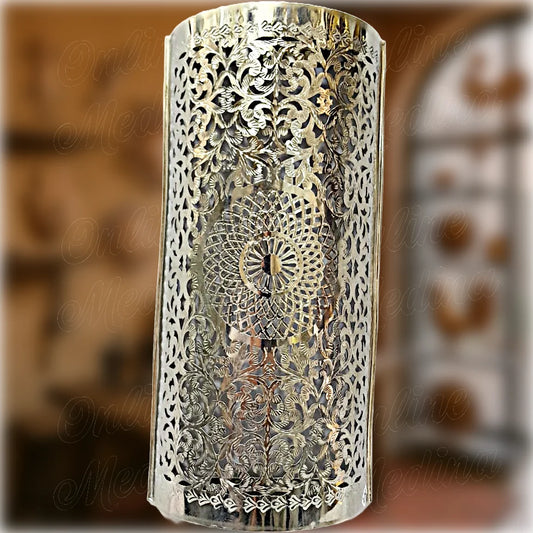 Traditional pierced brass wall lantern from Morocco, hand-cut and engraved with geometric and floral shapes – authentic Moroccan craftsmanship for cozy, ambient lighting.