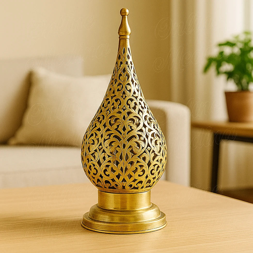 Moroccan brass floral candle lantern with pierced design, placed on a bright living room table.