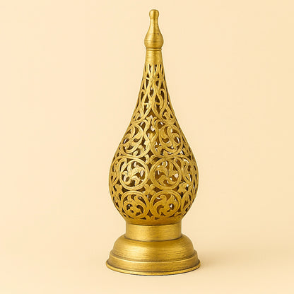 Brass Moroccan floral candle lantern with intricate openwork on a plain beige background.