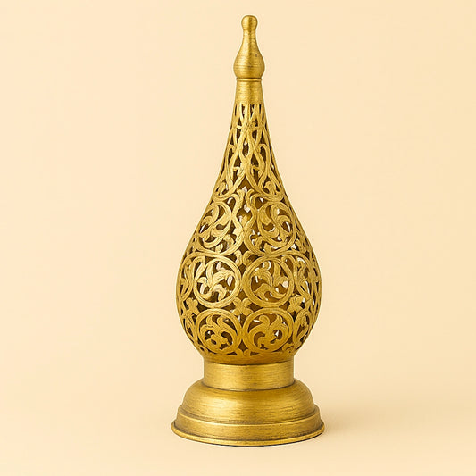 Brass Moroccan floral candle lantern with intricate openwork on a plain beige background.