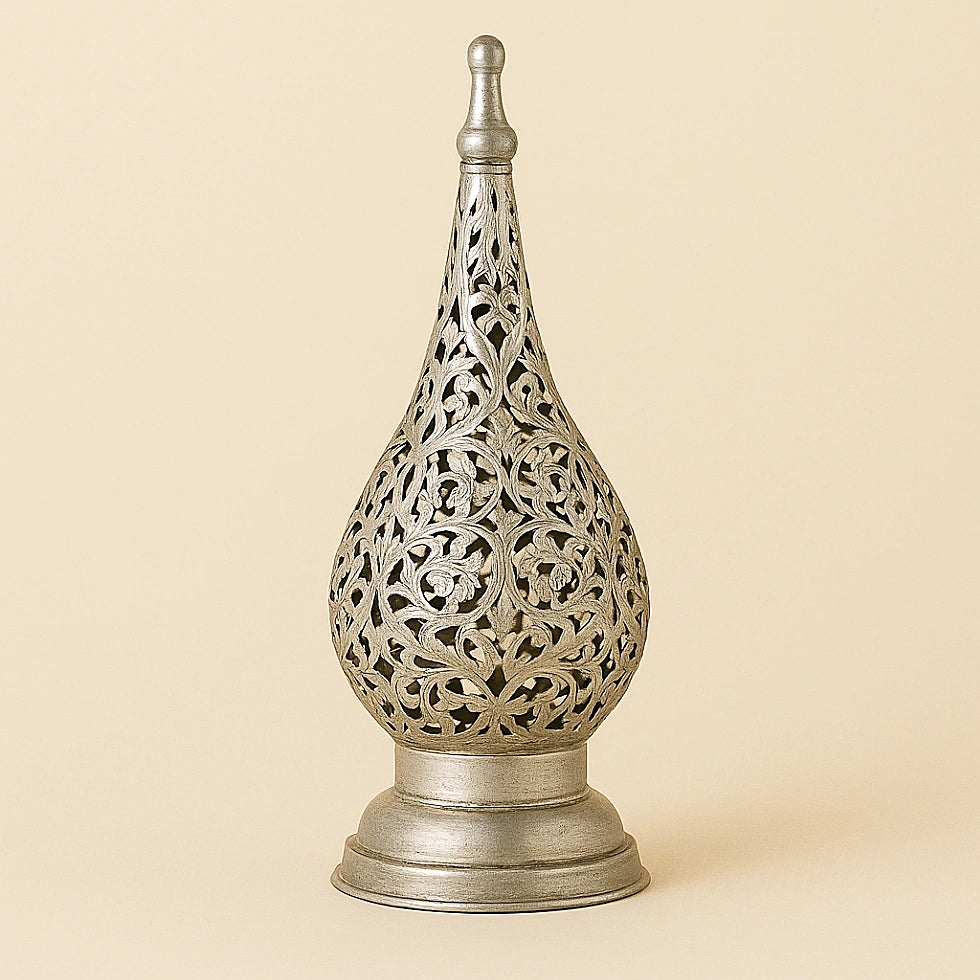 Silver Moroccan floral candle lantern with detailed filigree design on a plain beige background.