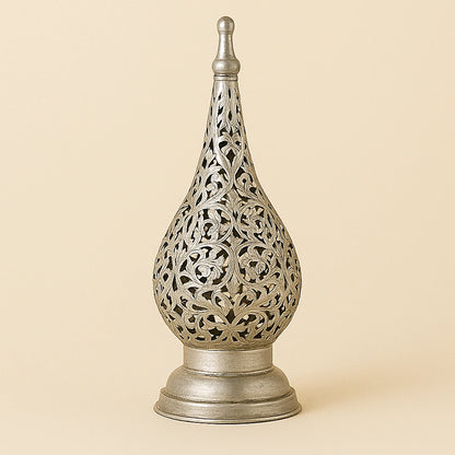 Silver Moroccan floral candle lantern with detailed filigree design on a plain beige background.