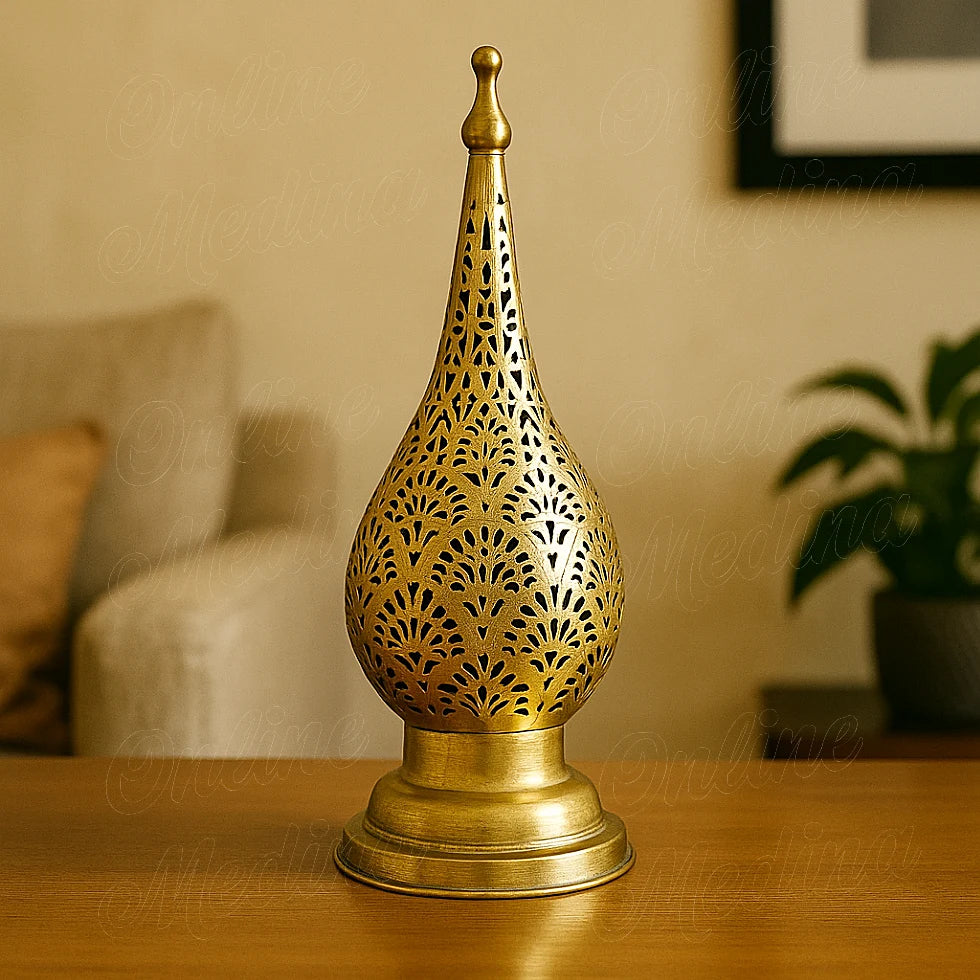 Moroccan brass candle lantern with oriental pattern placed on a bright living room table.