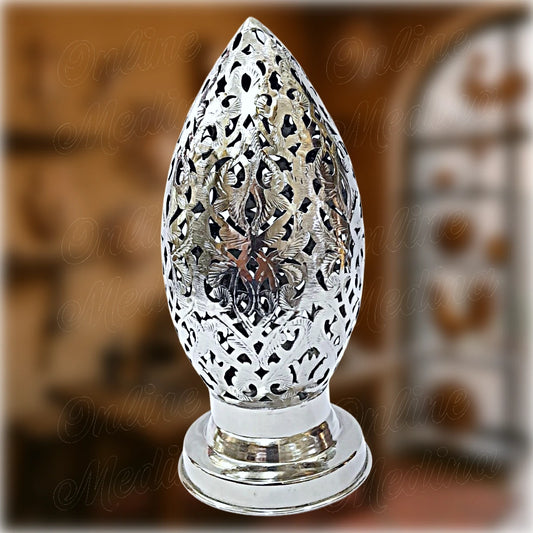 Silver Moroccan egg-shaped candle holder with intricate floral cutouts – handcrafted by Maître Hilab in Marrakech