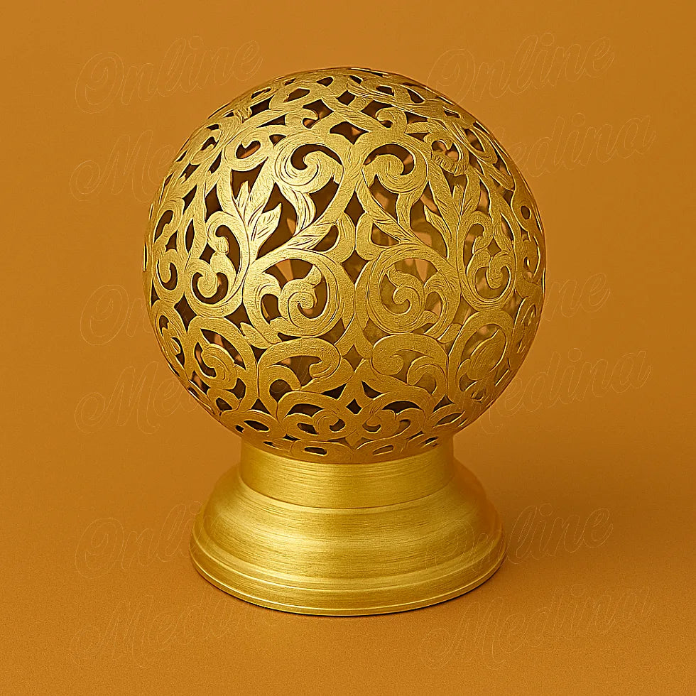 Brass Moroccan spherical candle holder with floral cutouts, handcrafted metal decor on warm background