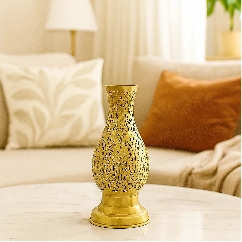 Brass filigree candle holder on a marble table in a cozy living room