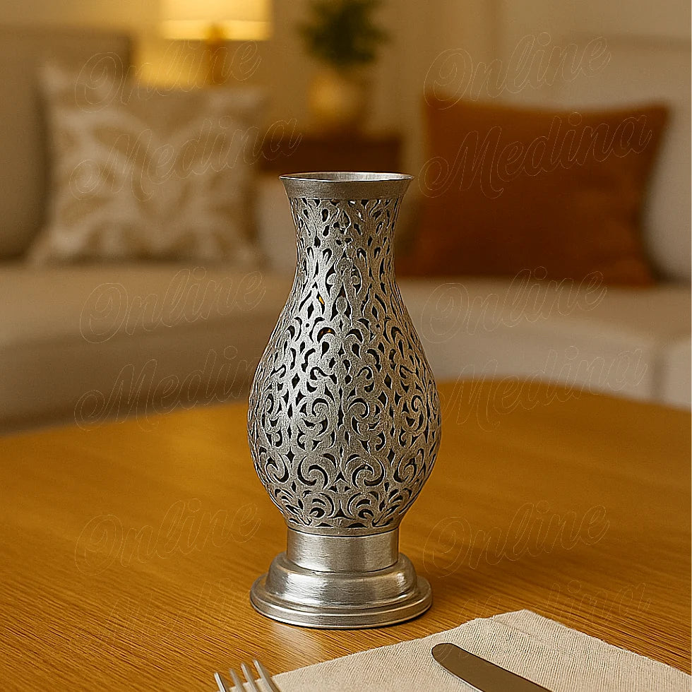 Silver filigree candle holder on a wooden table in a modern living room