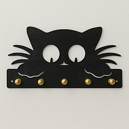 Black cat-shaped wall key holder with brass hooks on neutral wall