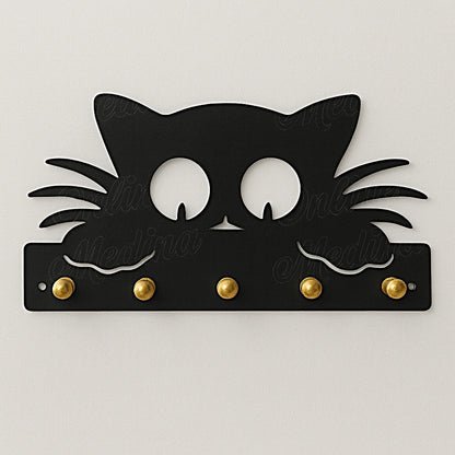 Black cat-shaped wall key holder with brass hooks on neutral wall