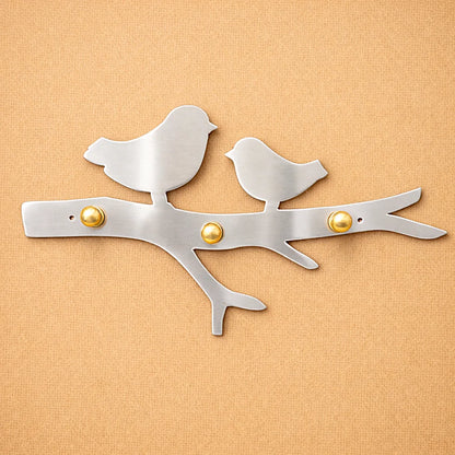 Smooth silver alloy bird wall key holder with brass hooks, handcrafted metal design for modern and minimalist interiors