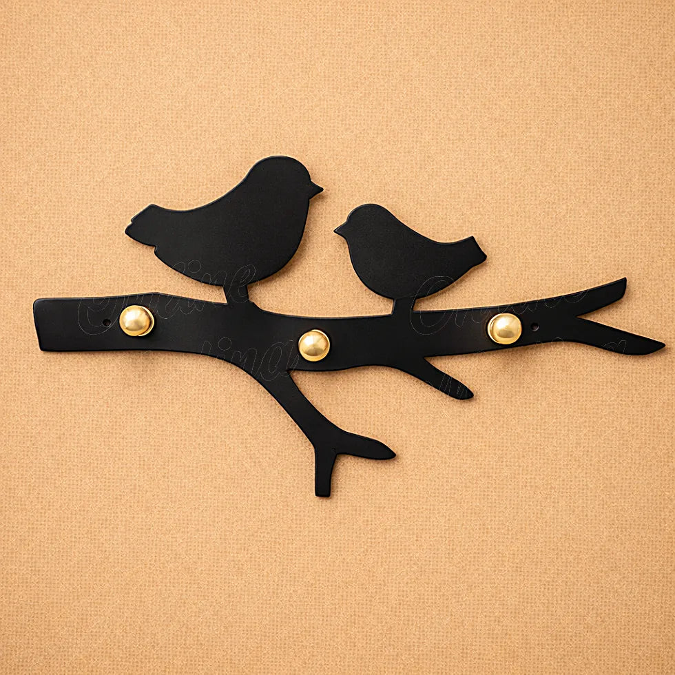 Black metal bird wall key holder with smooth finish and brass hooks, minimalist handcrafted wall accessory