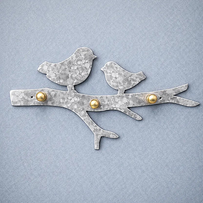 Hammered galvanized metal bird wall key holder with visible artisan texture and solid brass hooks