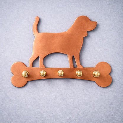 Handmade copper dog wall key holder with brass hooks shown on a neutral background